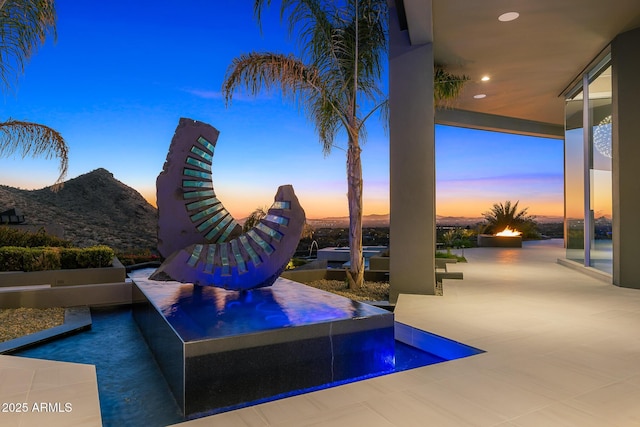 pool at dusk with a mountain view