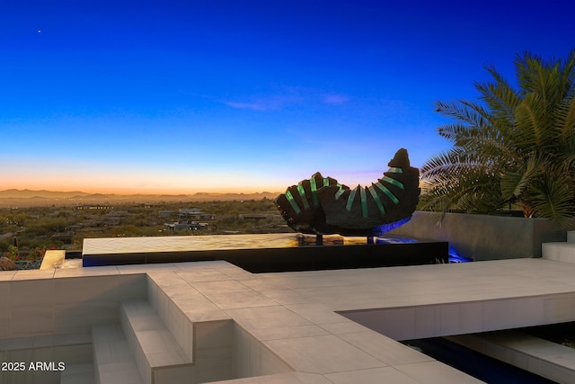 patio terrace at dusk with a mountain view