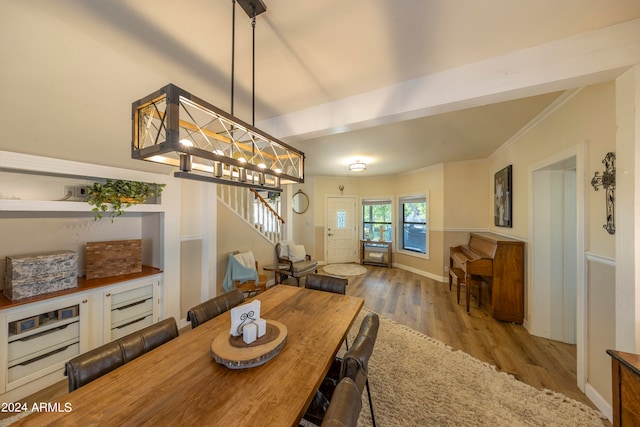 dining space featuring crown molding and hardwood / wood-style flooring