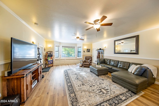 living room featuring light hardwood / wood-style floors, ornamental molding, and ceiling fan