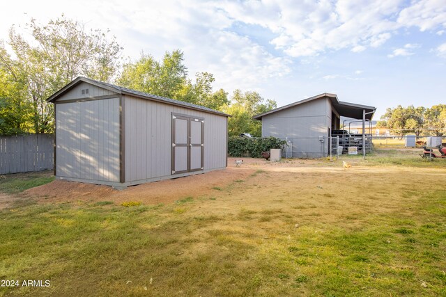 view of outbuilding with a lawn