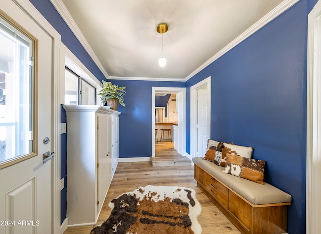 entryway featuring ornamental molding and light hardwood / wood-style flooring