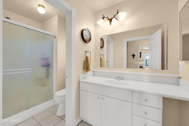 bathroom with vanity, tile patterned flooring, toilet, and walk in shower