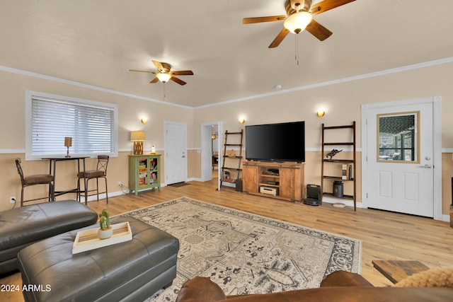 living room featuring ornamental molding, light hardwood / wood-style flooring, and ceiling fan