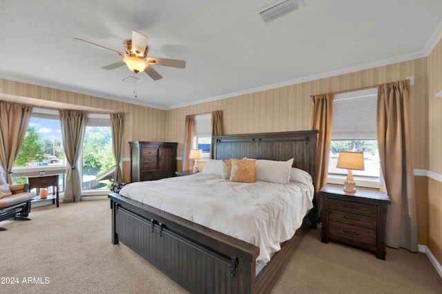 carpeted bedroom with multiple windows, ornamental molding, and ceiling fan