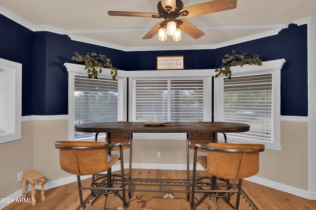 dining space featuring crown molding, wood-type flooring, and ceiling fan