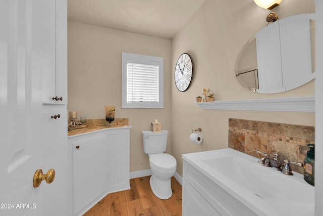 bathroom with vanity, hardwood / wood-style floors, and toilet