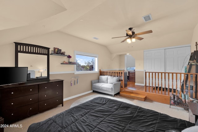 carpeted bedroom with lofted ceiling, a closet, and ceiling fan