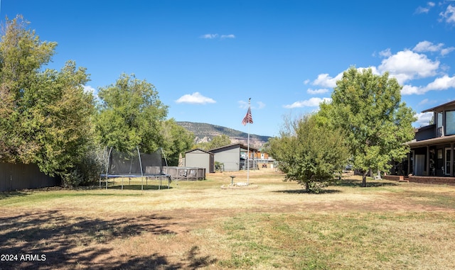 view of yard with a mountain view and a trampoline