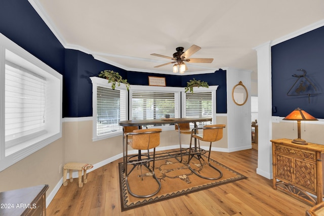 dining area with crown molding, wood-type flooring, and ceiling fan