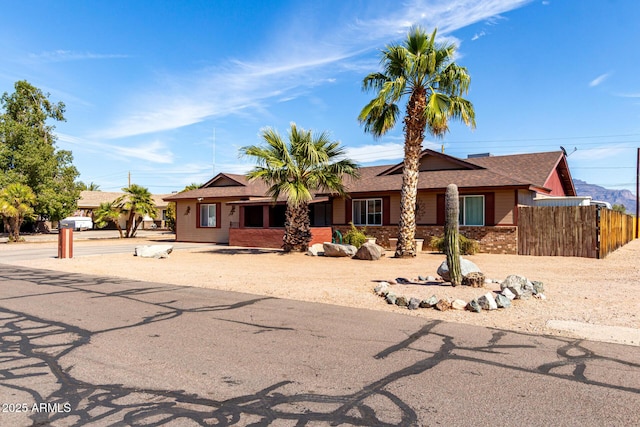 ranch-style house with brick siding and fence