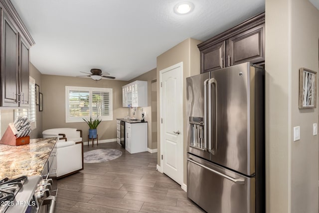 kitchen with dark brown cabinetry, baseboards, a ceiling fan, dark wood-style floors, and appliances with stainless steel finishes