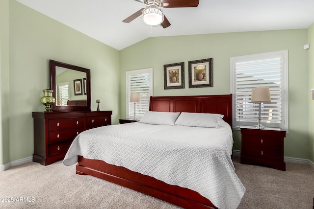 carpeted bedroom with lofted ceiling, ceiling fan, and baseboards