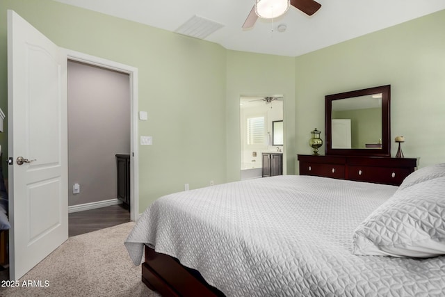 bedroom featuring ensuite bath, visible vents, ceiling fan, and baseboards