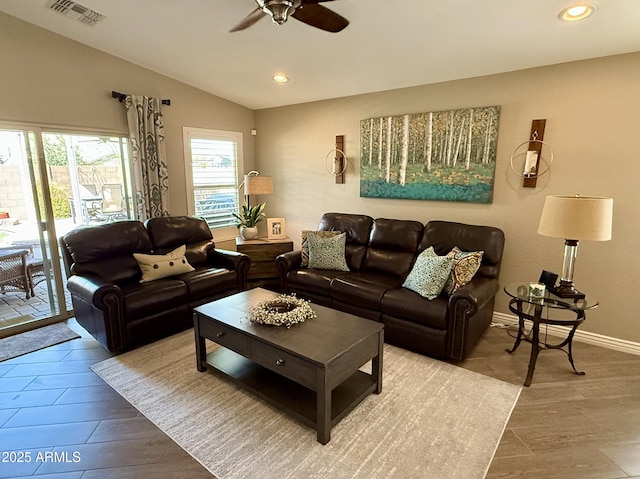 living area with lofted ceiling, visible vents, recessed lighting, and wood finished floors