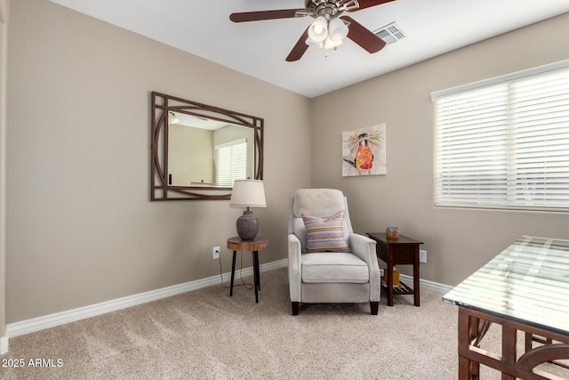 living area with carpet, visible vents, ceiling fan, and baseboards