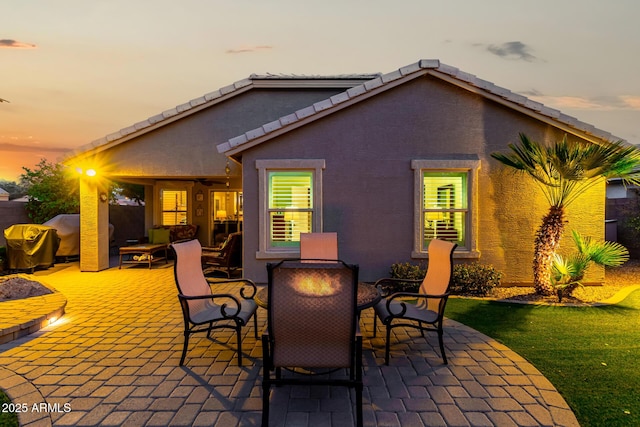 view of patio terrace at dusk