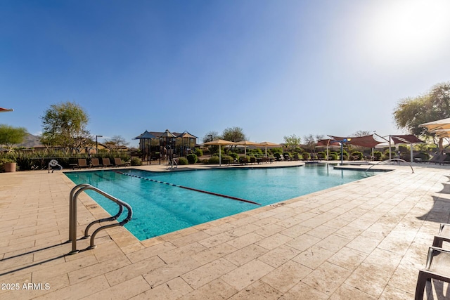 community pool featuring a patio area, fence, and a gazebo