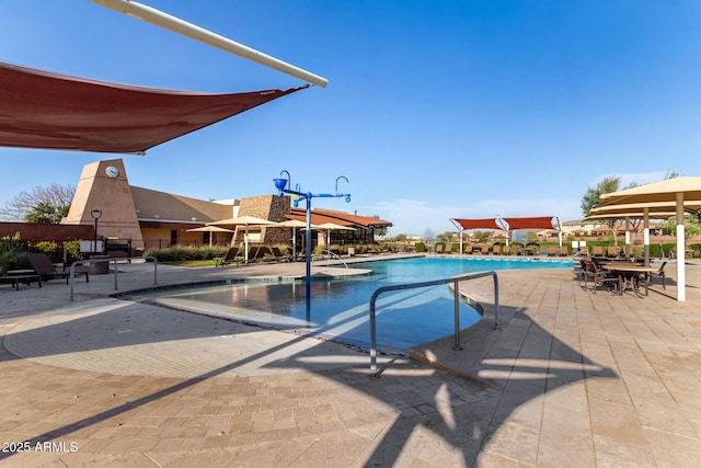 pool featuring fence and a patio