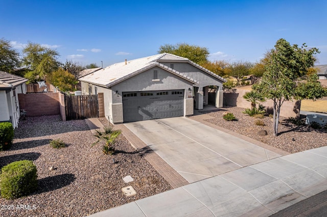 single story home featuring a garage, a tile roof, fence, driveway, and stucco siding