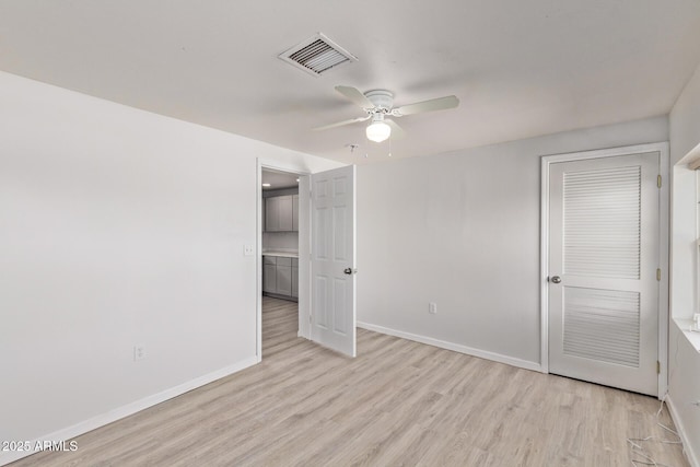 423 W Phoenix Ave, Eloy, AZ 85131 - unfurnished bedroom with a closet, light wood-style flooring, visible vents, baseboards, and a ceiling fan
