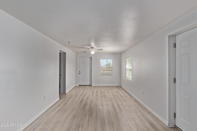 423 W Phoenix Ave, Eloy, AZ 85131 - empty room with baseboards, light wood-style floors, and ceiling fan
