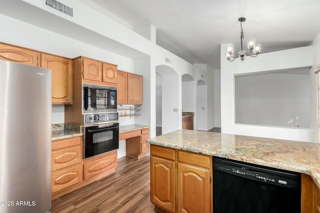 kitchen with light stone counters, a chandelier, light hardwood / wood-style flooring, pendant lighting, and black appliances