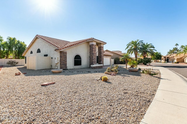 mediterranean / spanish home with a garage