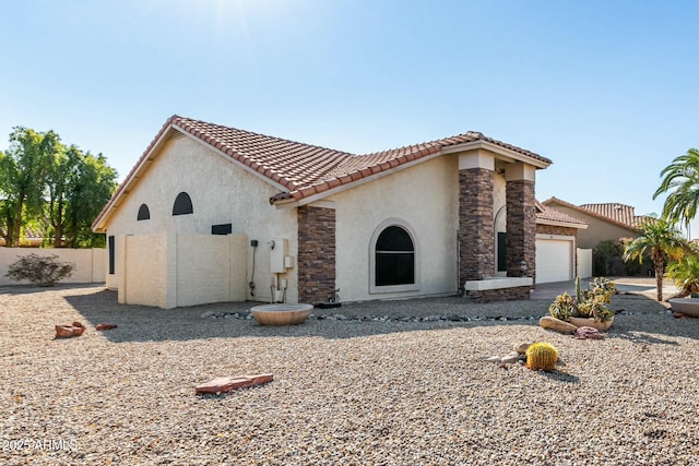 mediterranean / spanish-style home with a garage