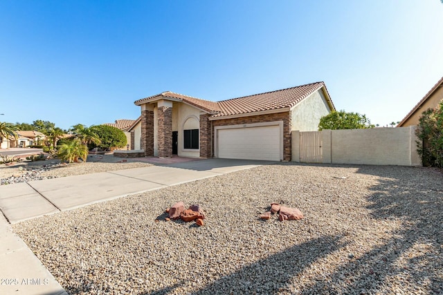 mediterranean / spanish home with a garage