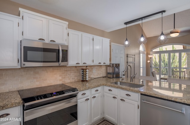 kitchen with white cabinets, stainless steel appliances, sink, and hanging light fixtures