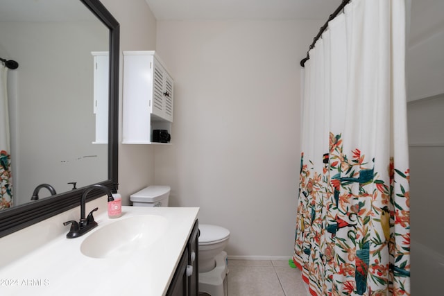 bathroom featuring vanity, toilet, walk in shower, and tile patterned flooring