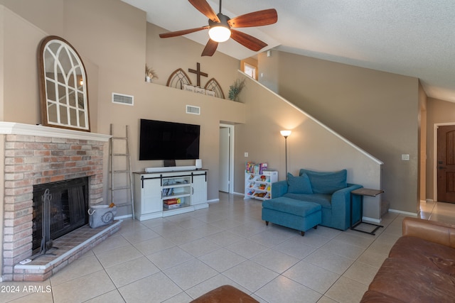 tiled living room with a textured ceiling, high vaulted ceiling, a fireplace, and ceiling fan