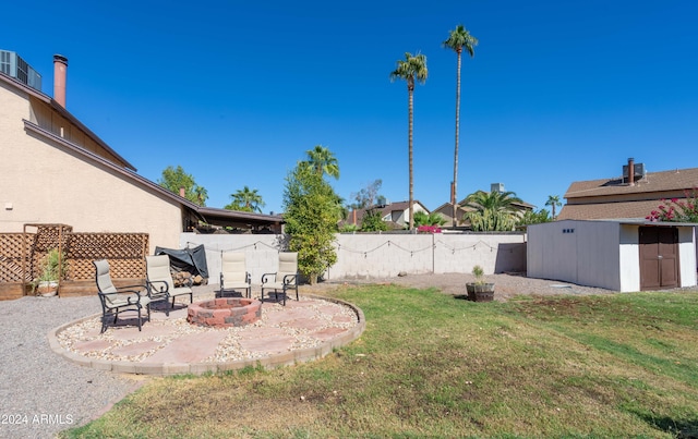 view of yard with a storage shed, a patio area, and a fire pit