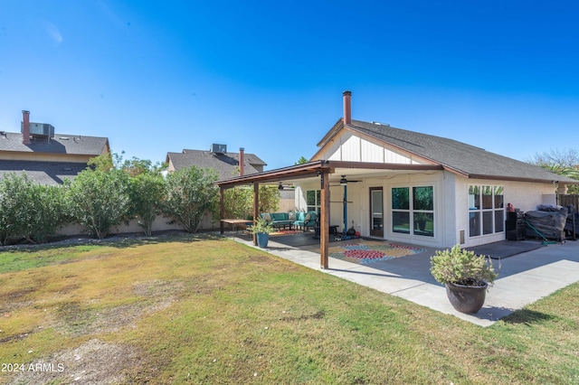 rear view of property featuring a patio area, a lawn, and ceiling fan