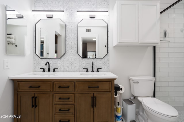 bathroom featuring vanity, a shower, decorative backsplash, and toilet