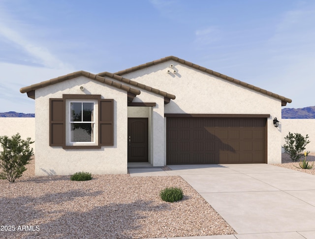 single story home featuring concrete driveway, a mountain view, a garage, and stucco siding
