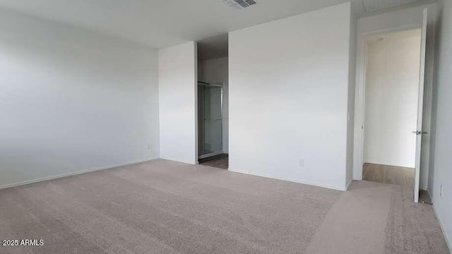unfurnished bedroom featuring carpet flooring and visible vents