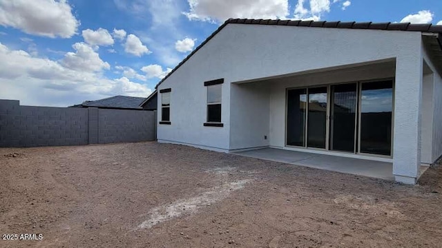 back of property featuring a patio, stucco siding, and fence