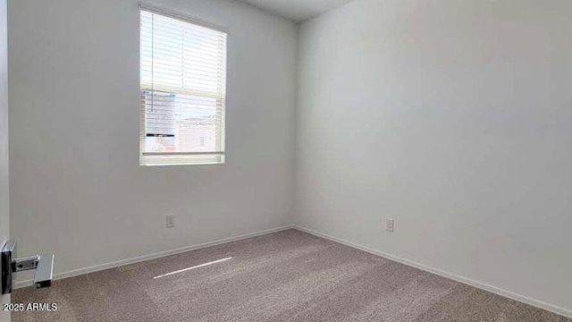 carpeted spare room with a wealth of natural light and baseboards