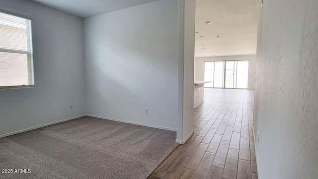 empty room with wood finished floors and baseboards