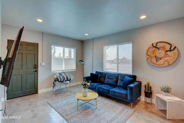 living room with concrete flooring and a wealth of natural light