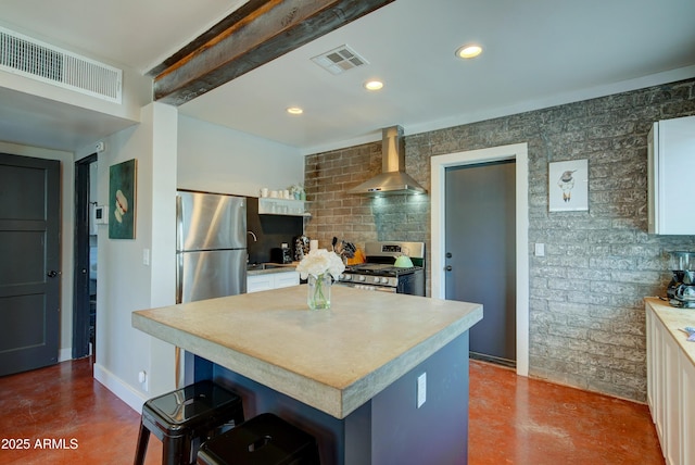 kitchen with appliances with stainless steel finishes, backsplash, a kitchen breakfast bar, a center island, and wall chimney exhaust hood