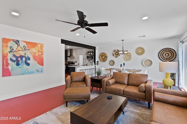 living room featuring light carpet, sink, and ceiling fan