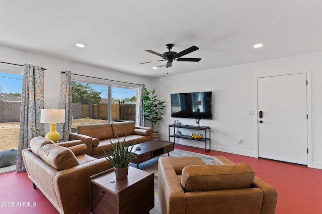 living room with ceiling fan and a healthy amount of sunlight