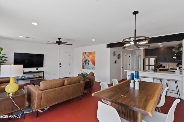 dining room with ceiling fan with notable chandelier