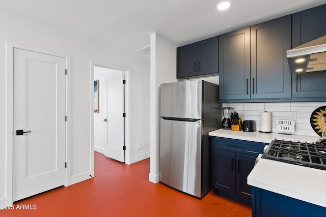 kitchen with tasteful backsplash, exhaust hood, blue cabinets, and stainless steel fridge