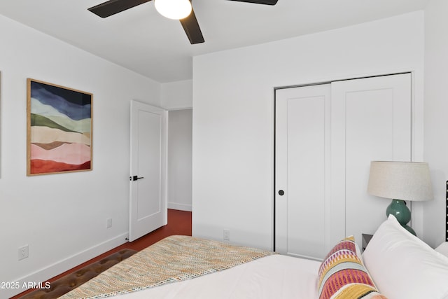 bedroom featuring ceiling fan and a closet