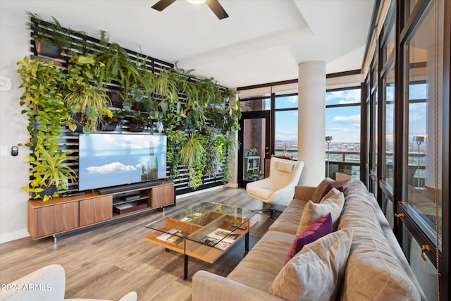 living room with ceiling fan, floor to ceiling windows, and wood-type flooring