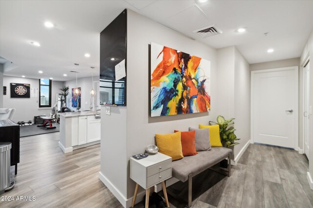 hallway with light hardwood / wood-style floors